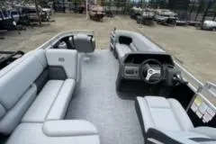 Slide: The Image of 2026 Sun Tracker SportFish 20 DLX pontoon boat in a parking area. - 7