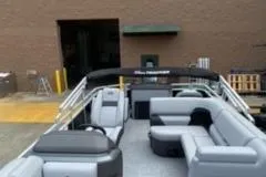 Slide: The Image of 2026 Sun Tracker SportFish 20 DLX pontoon boat interior with seating and steering console. - 8