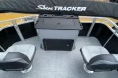 Slide: The Image of 2026 Sun Tracker SportFish 20 DLX pontoon boat with spacious seating, docked near a brick building. - 9