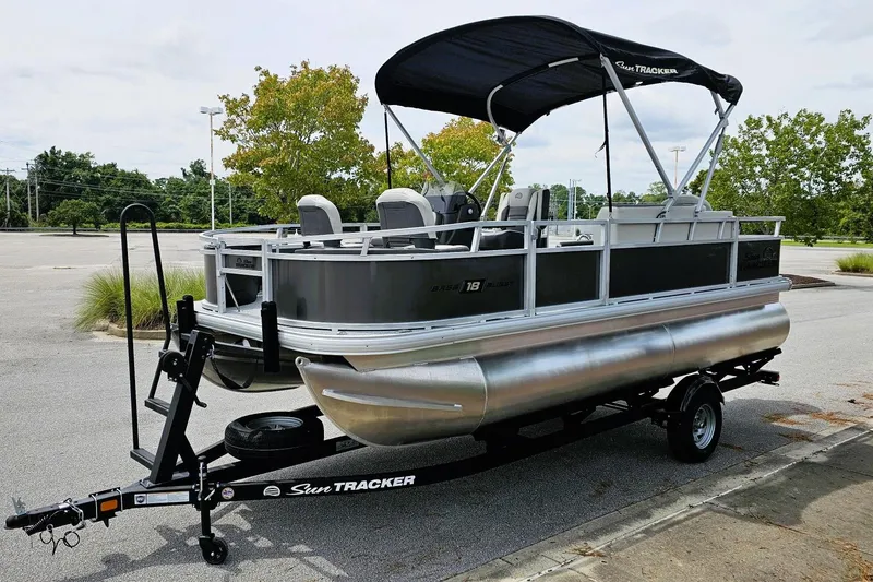 Slide: The Image of 2026 Sun Tracker Bass Buggy 18 DLX boat console with steering wheel and seating. - 6