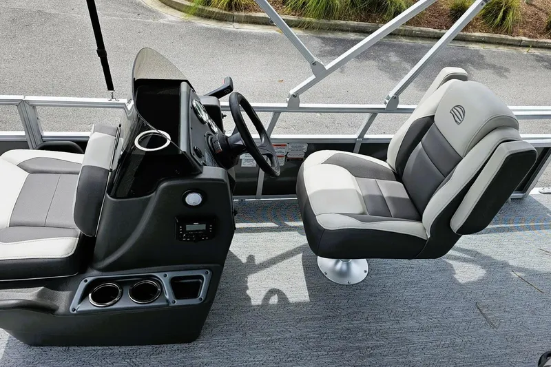 Slide: The Image of 2026 Sun Tracker Bass Buggy 18 DLX boat seating with cup holders, gray and black upholstery. - 7
