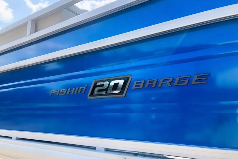 Slide: The Image of 2026 Sun Tracker Fishin' Barge 20 DLX, blue exterior with model name displayed. - 5