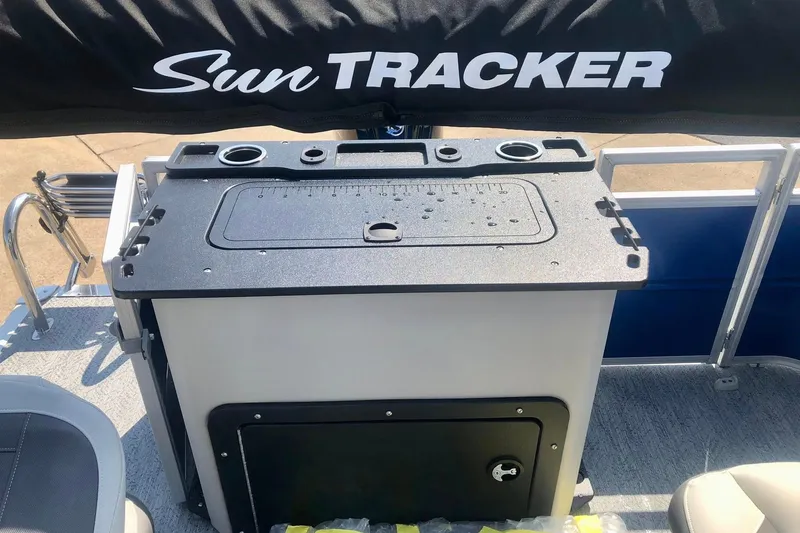 Slide: The Image of 2026 Sun Tracker Fishin' Barge 20 DLX with fishing station and storage compartment. - 6