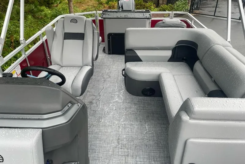 Slide: The Image of 2026 Sun Tracker SportFish 20 DLX pontoon boat interior with gray seating and steering console. - 70