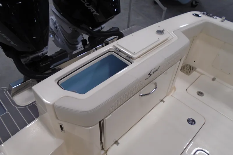Slide: The Image of 2026 Scout 288 LXF boat interior with storage compartment and dual Mercury engines. - 10