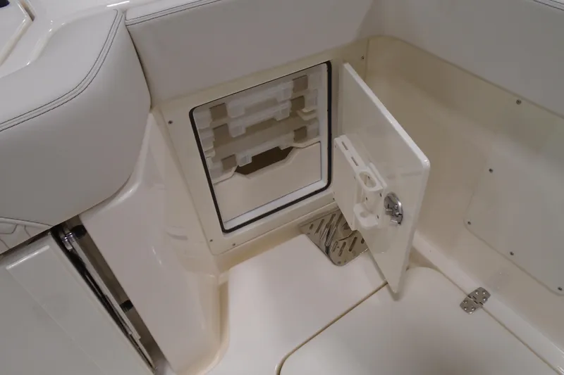 Slide: The Image of 2026 Scout 288 LXF boat storage compartment with open door, showcasing interior design. - 12