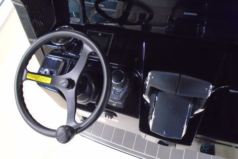 Slide: The Image of Steering wheel and controls of 2026 Scout 288 LXF boat dashboard. - 15