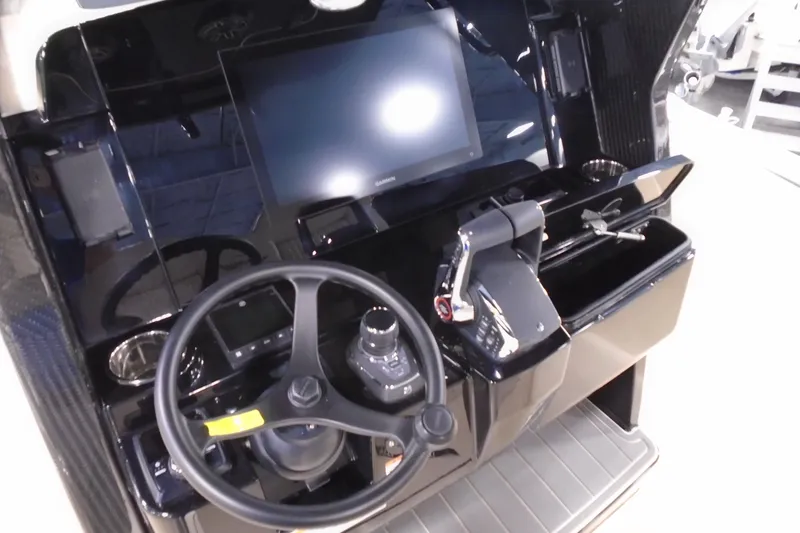 Slide: The Image of 2026 Scout 288 LXF boat dashboard with steering wheel and electronic controls. - 17