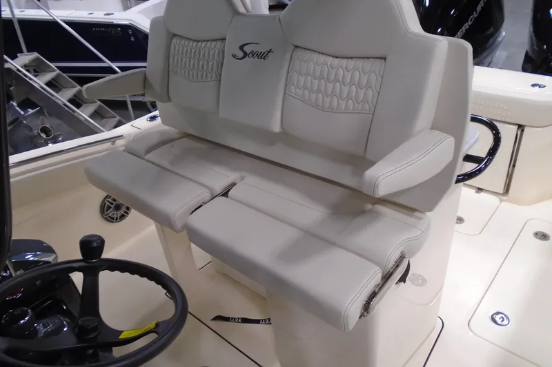 Slide: The Image of 2026 Scout 288 LXF boat interior with luxurious seating and steering wheel. - 18