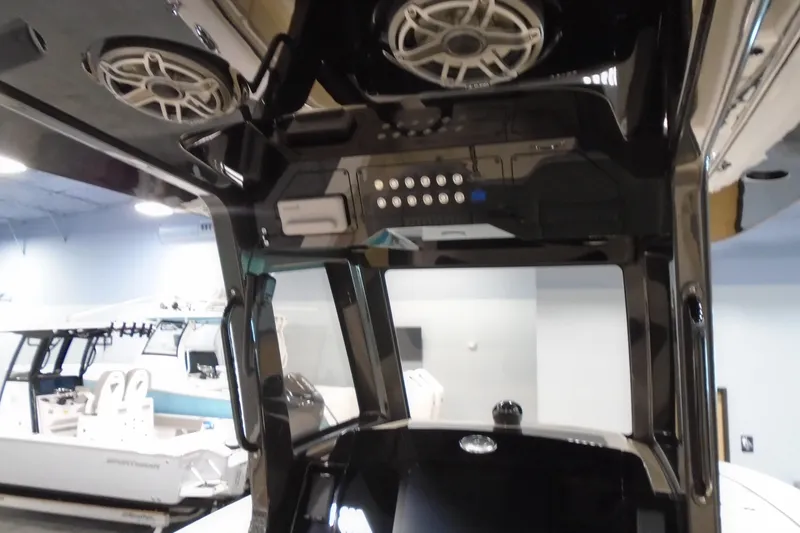 Slide: The Image of Interior view of 2026 Scout 288 LXF boat with advanced control panel and speakers. - 19