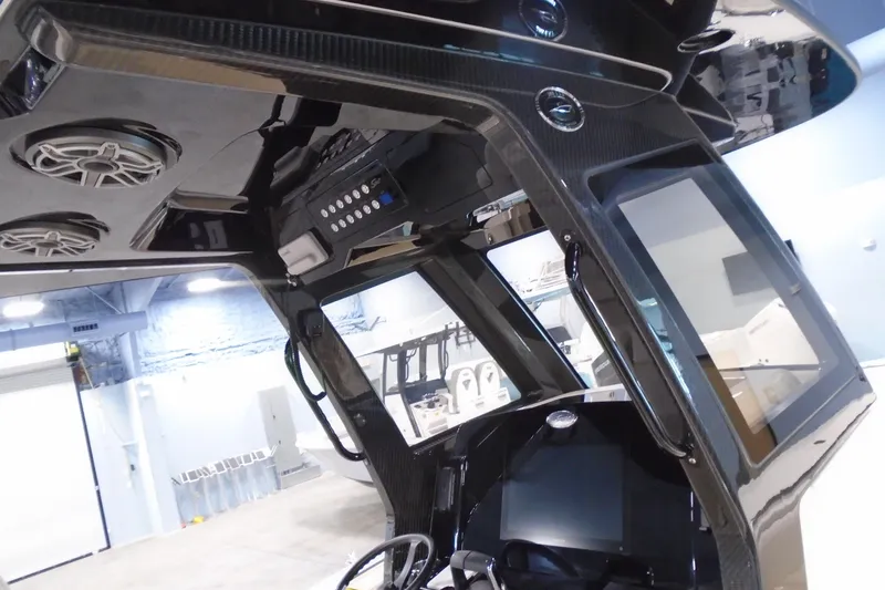 Slide: The Image of Interior view of 2026 Scout 288 LXF boat, featuring advanced control panel and speakers. - 20