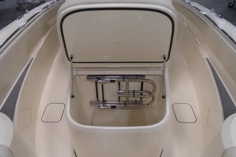 Slide: The Image of 2026 Scout 288 LXF boat storage compartment with open hatch and stainless steel ladder. - 23