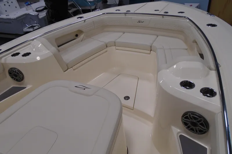 Slide: The Image of 2026 Scout 288 LXF boat interior with cushioned seating and cup holders. - 24