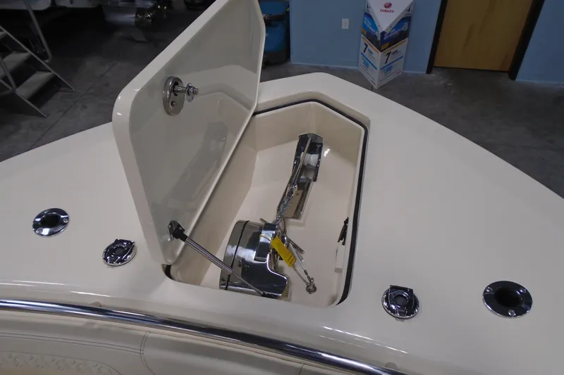 Slide: The Image of 2026 Scout 288 LXF boat anchor compartment with open hatch, showcasing sleek design. - 26