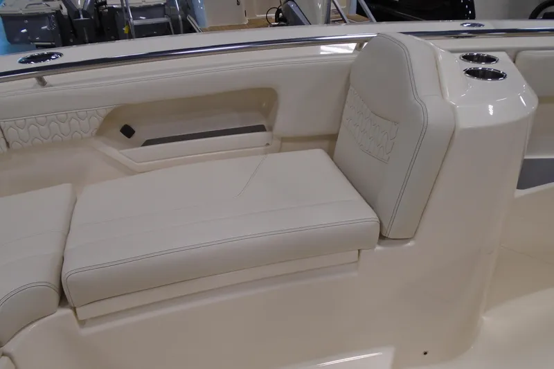 Slide: The Image of 2026 Scout 288 LXF boat interior with beige seating and cup holders. - 27