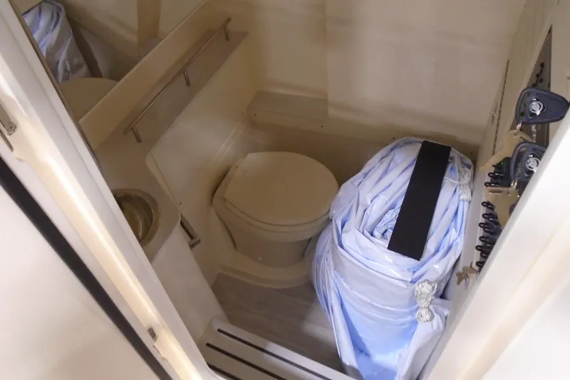 Slide: The Image of 2026 Scout 288 LXF boat interior with compact bathroom and storage area. - 32