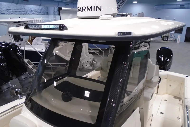 Slide: The Image of 2026 Scout 288 LXF boat with Garmin equipment, showcased indoors. - 36