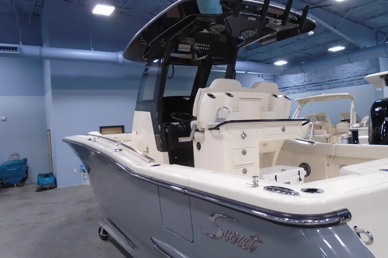 Slide: The Image of 2026 Scout 288 LXF boat in showroom, featuring sleek design and modern amenities. - 6