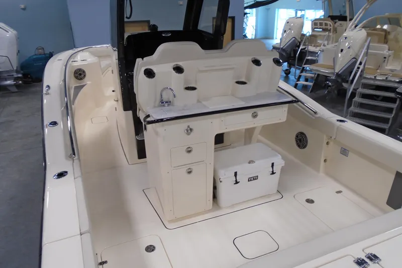 Slide: The Image of 2026 Scout 288 LXF boat interior with helm station and storage compartments. - 7