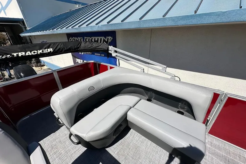 Slide: The Image of 2026 Sun Tracker Party Barge 18 DLX with gray seating and red paneling. - 13