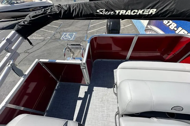 Slide: The Image of 2026 Sun Tracker Party Barge 18 DLX interior with seating and deck view. - 14
