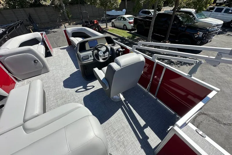 Slide: The Image of 2026 Sun Tracker Party Barge 18 DLX interior with seating and steering console. - 17