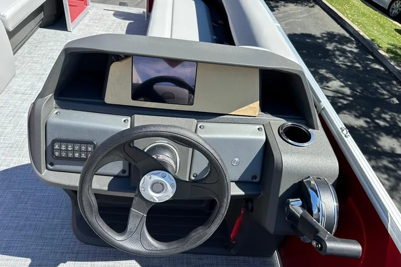 Slide: The Image of 2026 Sun Tracker Party Barge 18 DLX dashboard with steering wheel and control panel. - 20