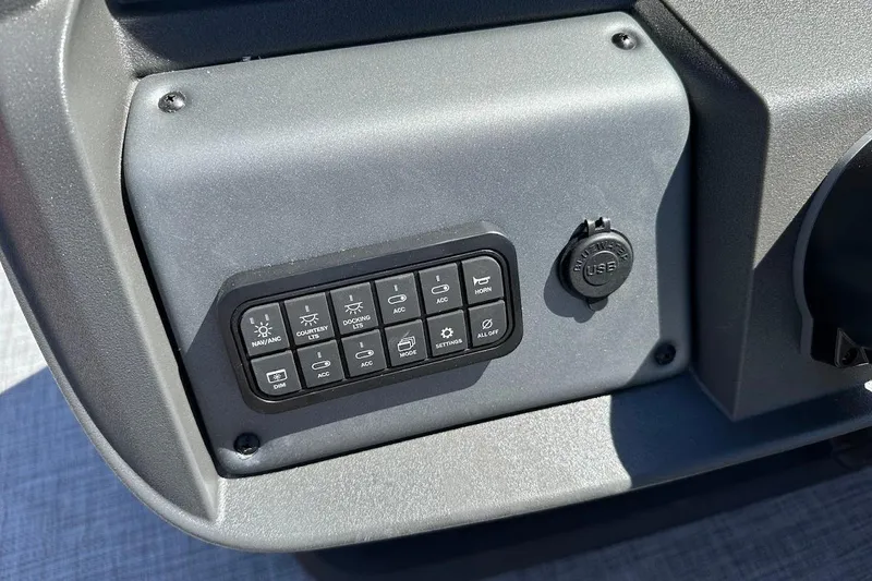 Slide: The Image of Control panel of 2026 Sun Tracker Party Barge 18 DLX with USB port and switches. - 22