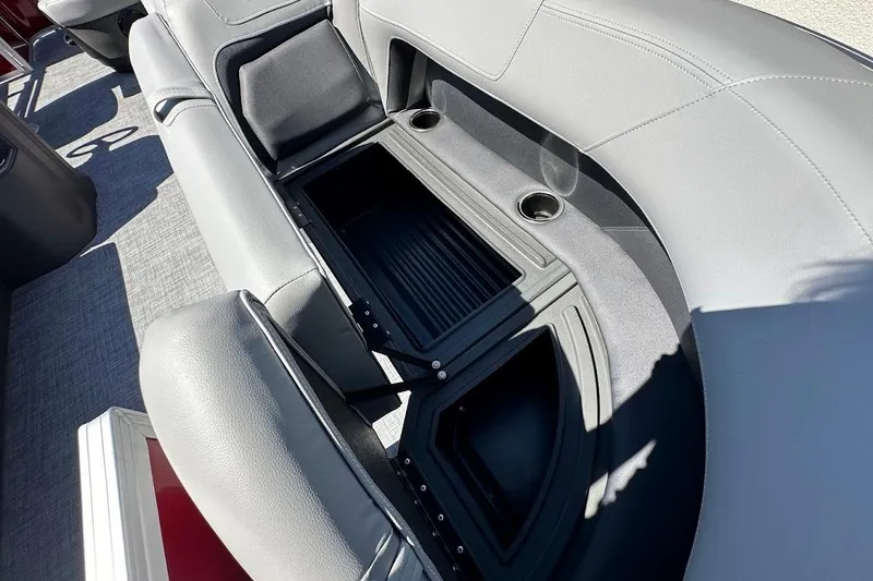 Slide: The Image of 2026 Sun Tracker Party Barge 18 DLX with open storage compartment and cup holders. - 25