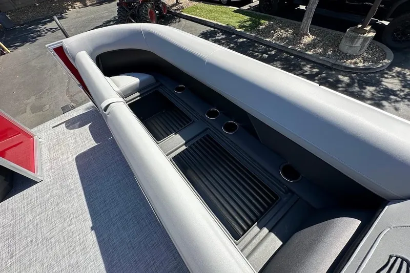 Slide: The Image of 2026 Sun Tracker Party Barge 18 DLX interior with gray seating and cup holders. - 26