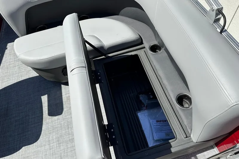 Slide: The Image of 2026 Sun Tracker Party Barge 18 DLX with open storage compartment and cup holders. - 27