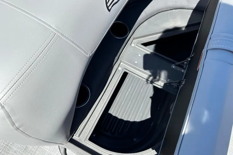 Slide: The Image of 2026 Sun Tracker Party Barge 18 DLX seat storage compartment with cup holders. - 28