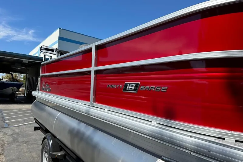 Slide: The Image of 2026 Sun Tracker Party Barge 18 DLX pontoon boat with vibrant red exterior. - 5