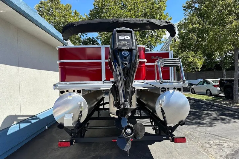 Slide: The Image of 2026 Sun Tracker Party Barge 18 DLX pontoon boat with 60 HP engine, parked outdoors. - 8