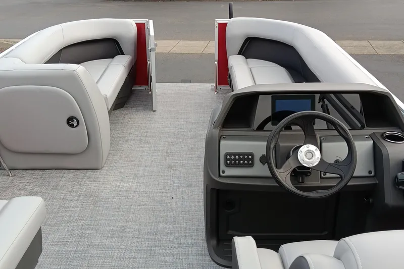 Slide: The Image of 2026 Sun Tracker Party Barge 18 DLX interior with steering console and seating. - 2