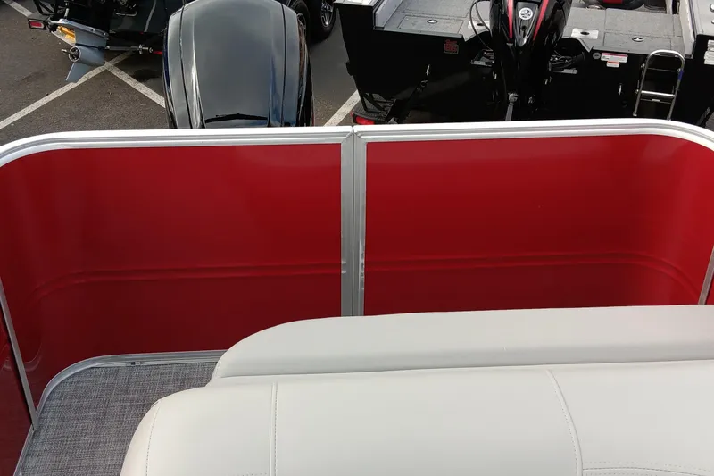 Slide: The Image of 2026 Sun Tracker Party Barge 18 DLX with red paneling and white seating. - 77