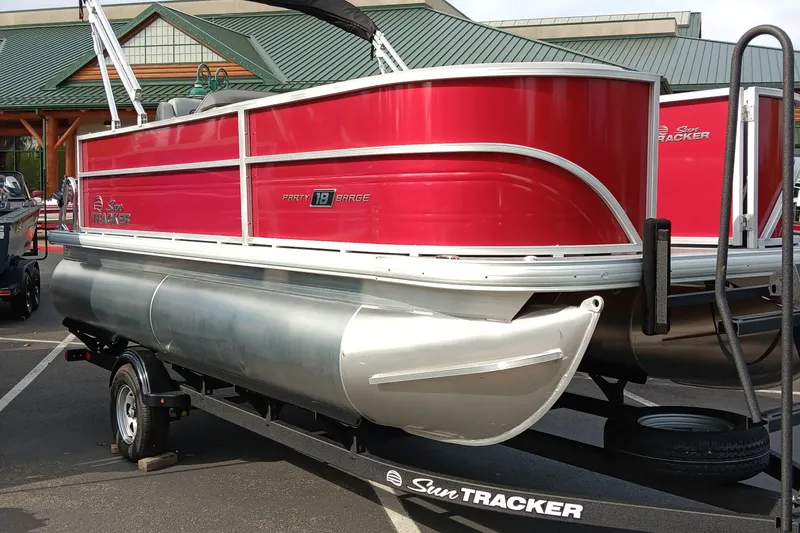 Slide: The Image of 2026 Sun Tracker Party Barge 18 DLX pontoon boat in vibrant red on trailer. - 78
