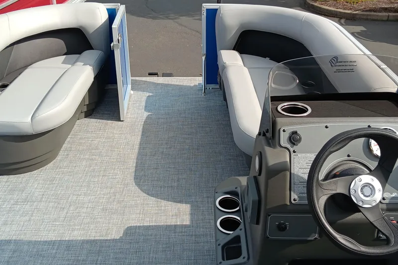 Slide: The Image of 2026 Sun Tracker Party Barge 16 DLX interior with seating and steering console. - 3