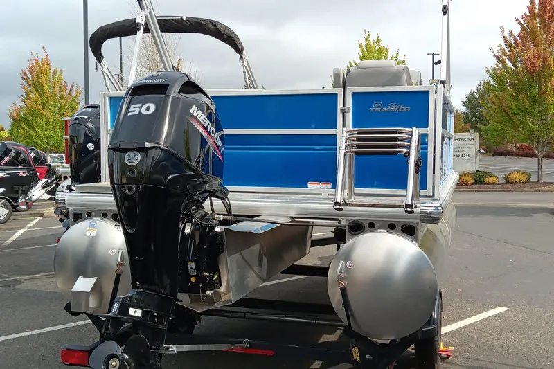 Slide: The Image of 2026 Sun Tracker Party Barge 16 DLX pontoon boat with Mercury 50 engine in parking lot. - 4