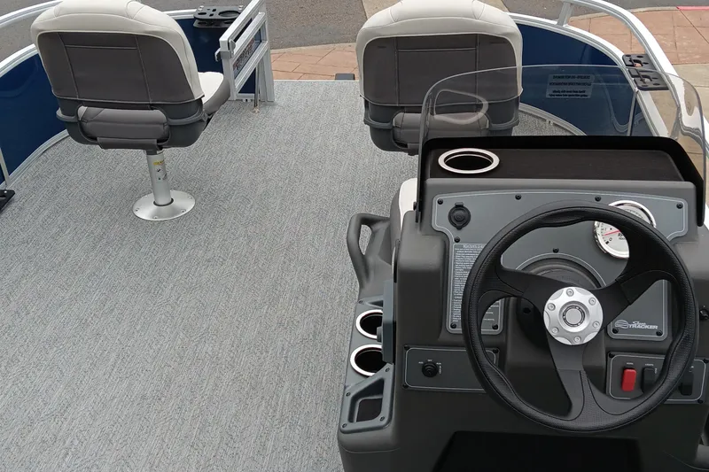 Slide: The Image of 2026 Sun Tracker Bass Buggy 16 XL Select interior with steering console and seating. - 2