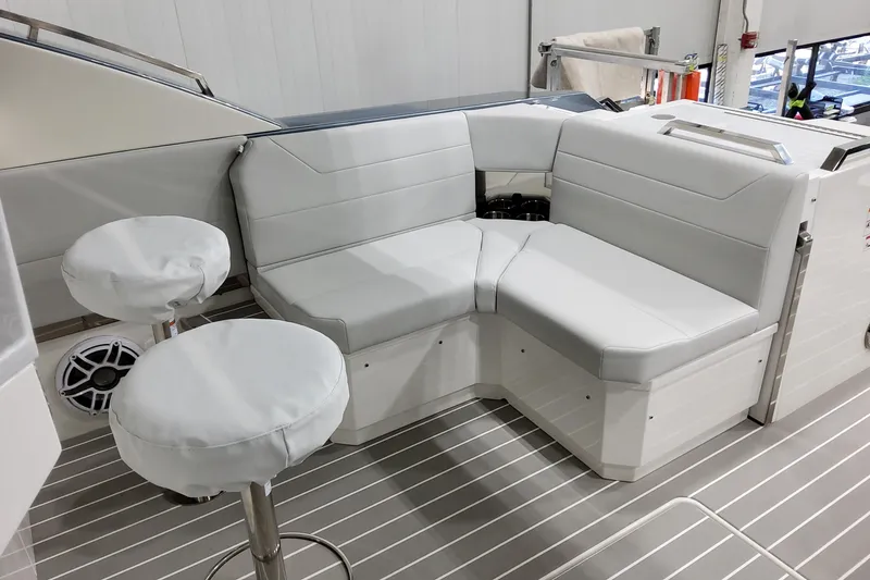 Slide: The Image of 2026 Formula 500 Super Sport Crossover boat interior with white seating and stools. - 36
