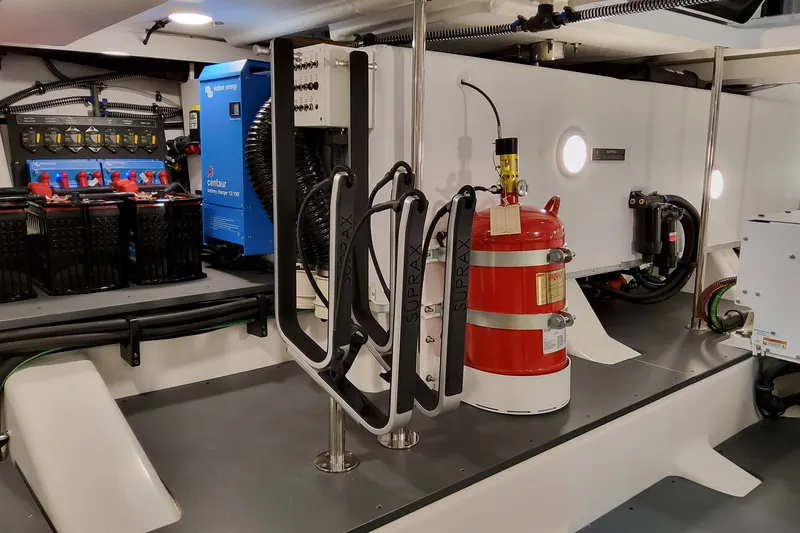 Slide: The Image of Engine room of 2026 Formula 500 Super Sport Crossover with batteries and fire extinguisher. - 56