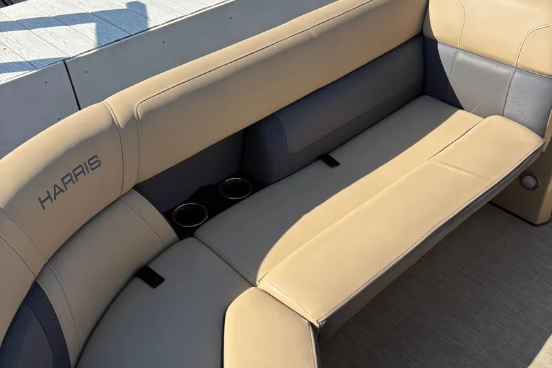 Slide: The Image of 2023 Harris Cruiser boat seat with beige upholstery and cup holders. - 6