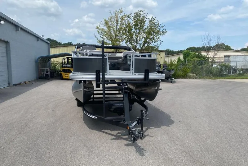Slide: The Image of 2026 Sun Tracker Bass Buggy 16 XL Select pontoon boat on trailer in parking lot. - 79