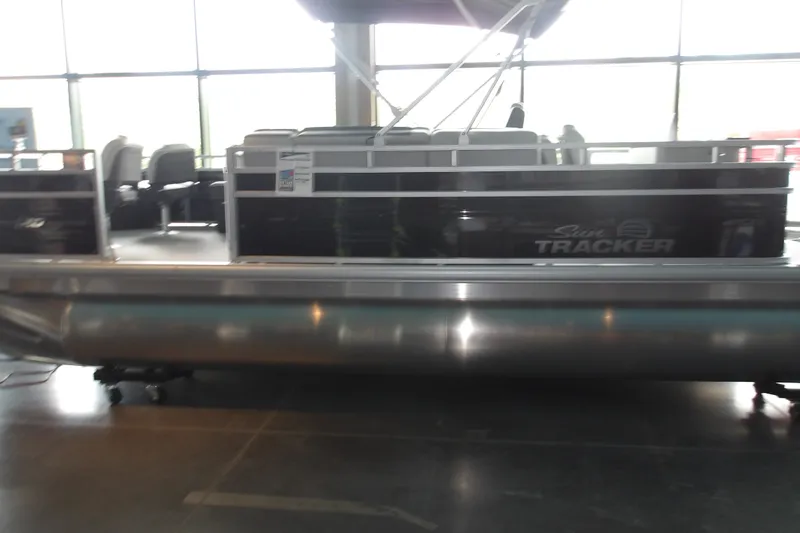 The Image of 2026 Sun Tracker Fishin' Barge 20 DLX pontoon boat displayed indoors. - 1