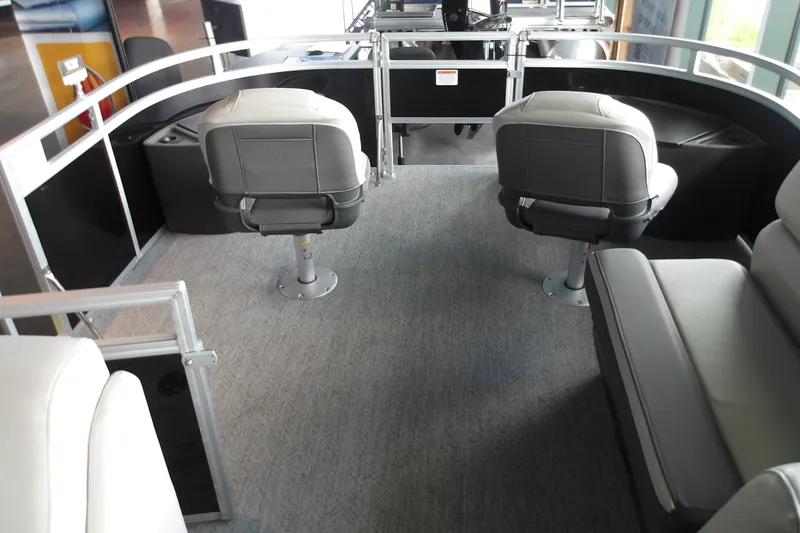 Slide: The Image of Interior of 2026 Sun Tracker Fishin' Barge 20 DLX with seating and helm. - 20
