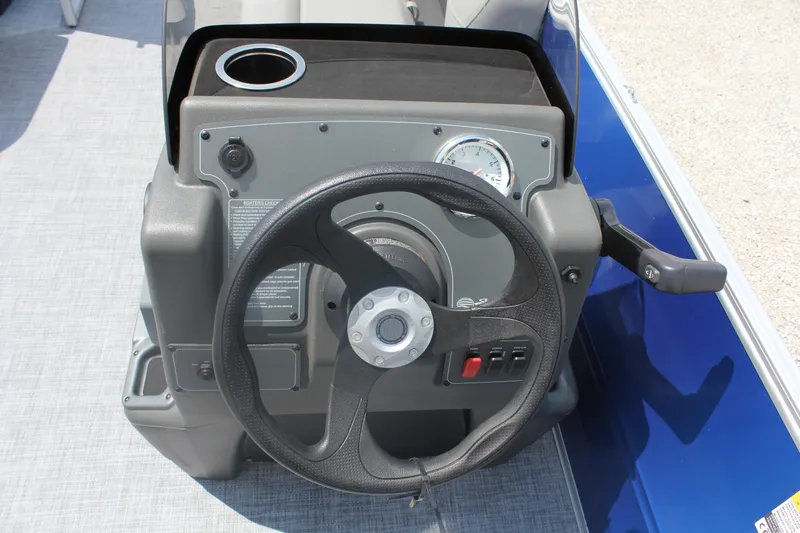 Slide: The Image of Steering console of 2026 Sun Tracker Party Barge 16 DLX with cup holder and controls. - 12