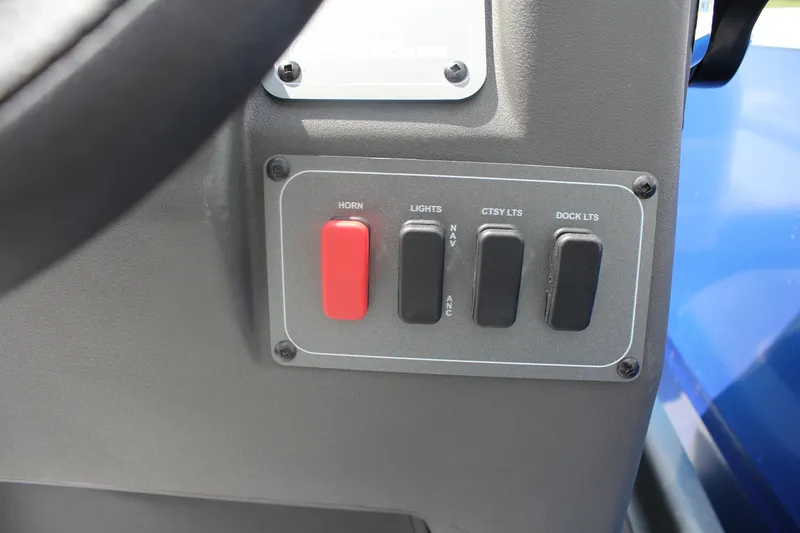 Slide: The Image of Control panel of 2026 Sun Tracker Party Barge 16 DLX with switches for horn and lights. - 13