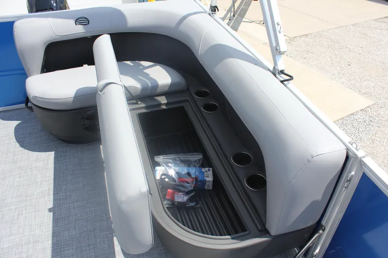 Slide: The Image of 2026 Sun Tracker Party Barge 16 DLX interior seating with storage and cup holders. - 17