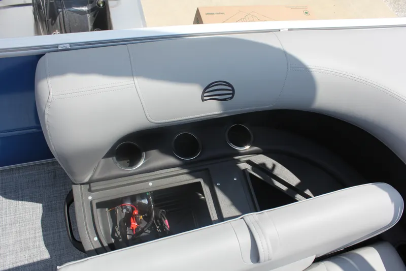 Slide: The Image of 2026 Sun Tracker Party Barge 16 DLX interior with cup holders and storage compartment. - 18